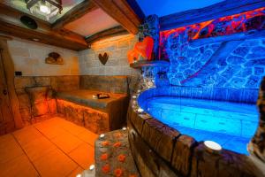a large bathroom with a tub and a shower at Complex Starite Kashti in Razvalini Balchikioy