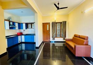 a living room with a couch and a ceiling fan at Hotel SK Temple View in Tiruvannāmalai