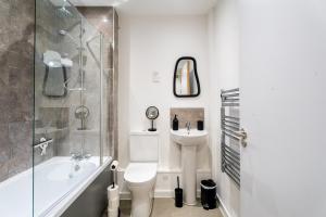 a bathroom with a toilet and a sink and a shower at Comfy One BR | Free Parking in Taunton +14 photos