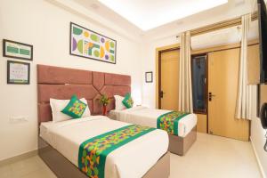 a hotel room with two beds and a window at Treebo Premium Inn 62 in Noida +27 photos