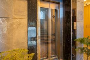 a glass door on the side of a building at Treebo Premium Inn 62 in Noida