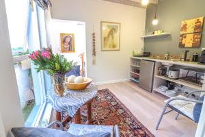 a kitchen with a table with a bowl of eggs on it at Airconditioned Apartment for 3 guests. in Hermanus +15 photos