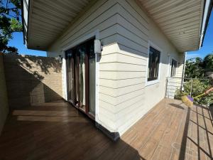a porch of a house with a wooden deck at Cambridge Guest House in Mandaue City