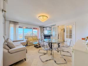 a living room with a table and a couch at Parque Marbella Three Bedroom Apartment in Marbella