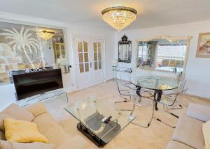 a living room with a couch and a tv at Parque Marbella Three Bedroom Apartment in Marbella