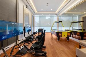 a room with a gym with a ping pong table at Grande Centre Point Hotel Terminal21 in Bangkok