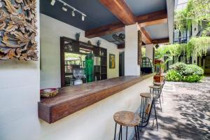 a bar with stools on the side of a building at Palette Resort Argya Santi Jimbaran in Jimbaran