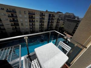 a balcony with a swimming pool on a building at Inis apartamans -50 m from beach in Shëngjin