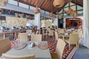 a restaurant with tables and chairs and a bar at Palette Resort Argya Santi Jimbaran in Jimbaran +73 photos