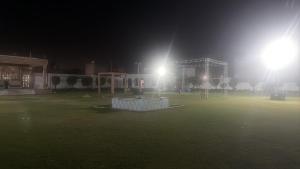 a field at night with two lights on at Purav Hotel in Kharkhauda