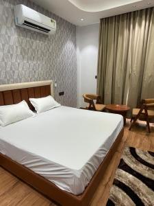a bedroom with a bed and a air conditioner on the wall at Purav Hotel in Kharkhauda