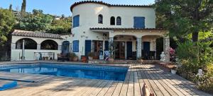 a house with a swimming pool in front of it at Casa Mimosa, Calonge Cabanyes in Calonge