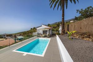 a swimming pool in the backyard of a house at Casa Yuliana in Tijarafe