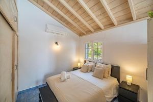 a bedroom with a bed with two night stands and a window at Casa Yuliana in Tijarafe +18 photos