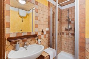 a bathroom with a sink and a shower at Meravigliosa Terrazza Vista Mare in Tresnuraghes +32 photos