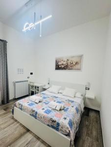 a bedroom with a bed in a white room at Conte Cavour B&B in Peschici