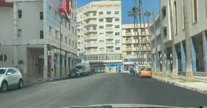 a city street with cars parked on the side of the road at Apartment Centre Hamria in Meknès