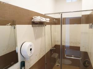 a bathroom with a shower with a glass door at Vy An Hotel in Bảo Lộc