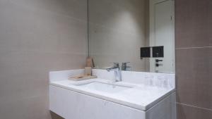 a white bathroom with a sink and a mirror at شقق فندقيه رسال in Ar Riyāḑ +52 photos