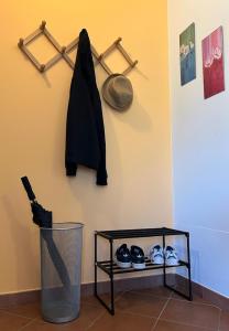 a shelf with shoes and a hat on a wall at Casa Luciana in Mergozzo