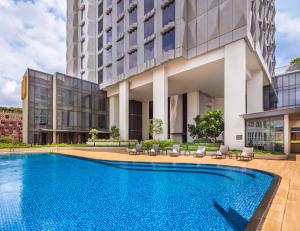 a swimming pool in front of a building at Hotel Mi Rochor in Singapore