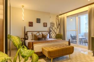 a bedroom with a king sized bed and a balcony at Hotel Bawa Udaipur in Udaipur +37 photos