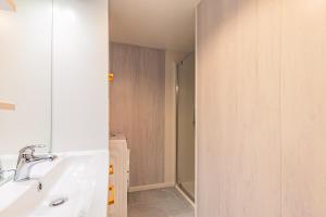a bathroom with a sink and a shower at Maison de vacances La Menou in Saint-Pierre-dʼOléron +23 photos