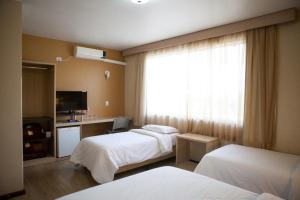 Postel nebo postele na pokoji v ubytování Hotel Palmeiras