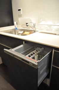 an open drawer in a kitchen with a sink at waen in Karahashi Rashomon +21 photos