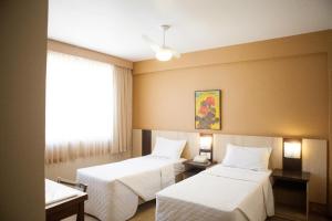 Postel nebo postele na pokoji v ubytování Hotel Palmeiras