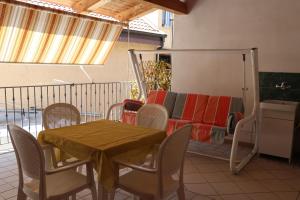 a patio with a table and chairs and a couch at BlueBay room Calabria in Vibo Valentia Marina