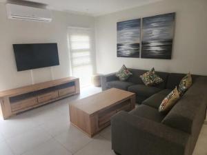 a living room with a couch and a flat screen tv at Serena in Gueima