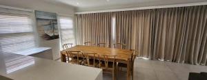 a dining room with a wooden table and chairs at Serena in Gueima