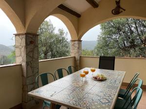 a table with glasses of orange juice on a balcony at Casa Mimosa, Calonge Cabanyes in Calonge
