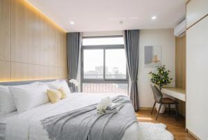 a bedroom with a bed with a desk and a window at Santori studio Hanoi in Hanoi +109 photos