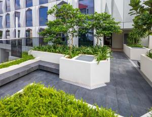a courtyard in a building with trees and plants at Hotel Mi Rochor in Singapore