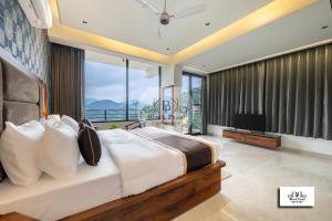 a bedroom with a large bed and a television at Maverick Heights in Kasauli