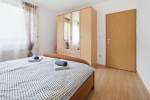 a bedroom with a bed with two towels on it at House Molnar in Kočevje