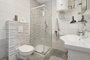 a bathroom with a toilet and a shower and a sink at House Molnar in Kočevje