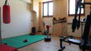 a room with a gym with a mat and a punching bag at Hotel Casa Vacanze Orchidea in Pinerolo