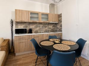 a kitchen with a table and chairs in a room at Casa Plati 1 - Modern Escape with Pool & Garden in Platí