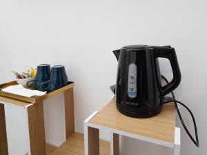 a black tea kettle sitting on top of a table at Incoming Medina in Naples +79 photos
