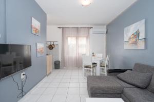 a living room with a couch and a table at Apartments Zeljko in Pag