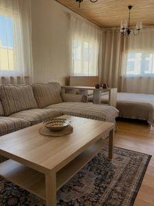 a living room with a couch and a coffee table at Malūno namai 2 in Palanga