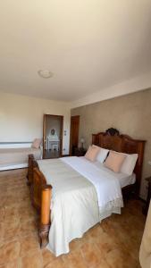 a bedroom with a large bed with white sheets at B&B La Pitagora in Porto Garibaldi