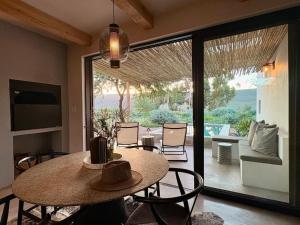 a dining room with a table and a patio at Lucky Crane Villas in McGregor