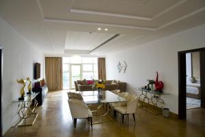 a living room with a table and a couch at Alammariah Hills Resort- Riyadh in Diriyah