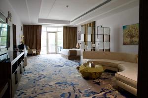 a living room with a couch and a table at Alammariah Hills Resort- Riyadh in Diriyah