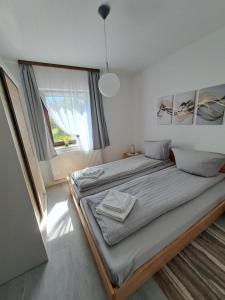 a large bed in a room with a large window at Ferienwohnung Natalia in Thalfang