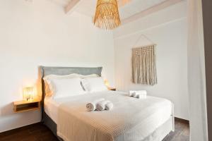 a bedroom with a bed with two towels on it at Lambda Luxury Villa 1 in Syvota +37 photos